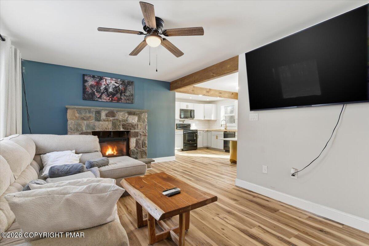 3279 Beech Ridge Drive Pocono Summit, PA 18346 - Photo 13 of 37 a living room with furniture a flat screen tv and a fireplace