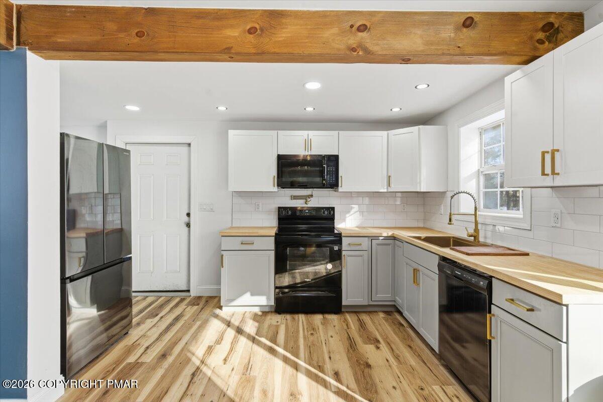 3279 Beech Ridge Drive Pocono Summit, PA 18346 - Photo 19 of 37 a kitchen with a sink stainless steel appliances and cabinets