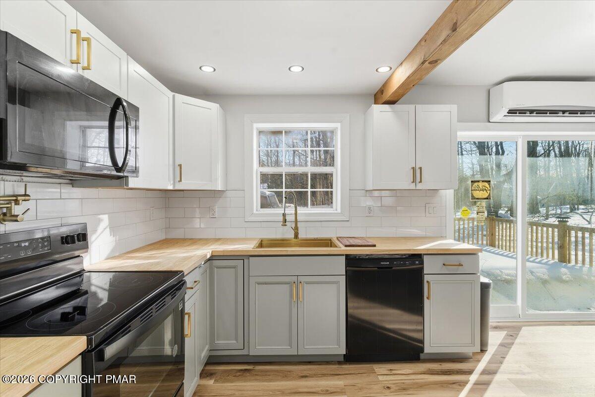 3279 Beech Ridge Drive Pocono Summit, PA 18346 - Photo 20 of 37 a kitchen with stainless steel appliances granite countertop a sink stove and cabinets