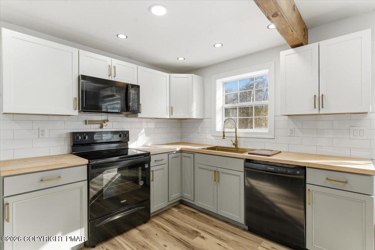 3279 Beech Ridge Drive Pocono Summit, PA 18346 - Photo 22 of 37 a kitchen with a sink stove and microwave