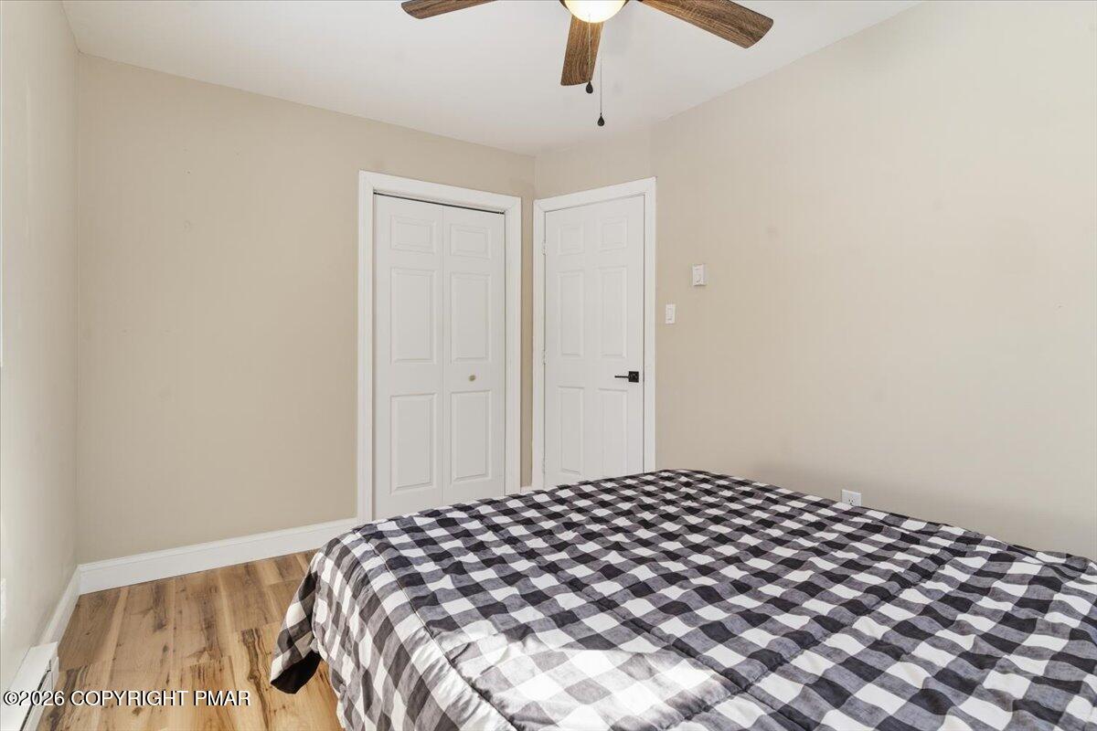 3279 Beech Ridge Drive Pocono Summit, PA 18346 - Photo 28 of 37 a bedroom with a bed and a view of a chandelier