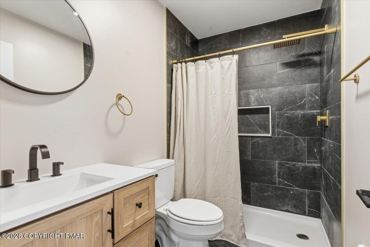 3279 Beech Ridge Drive Pocono Summit, PA 18346 - Photo 31 of 37 a bathroom with a sink toilet and shower