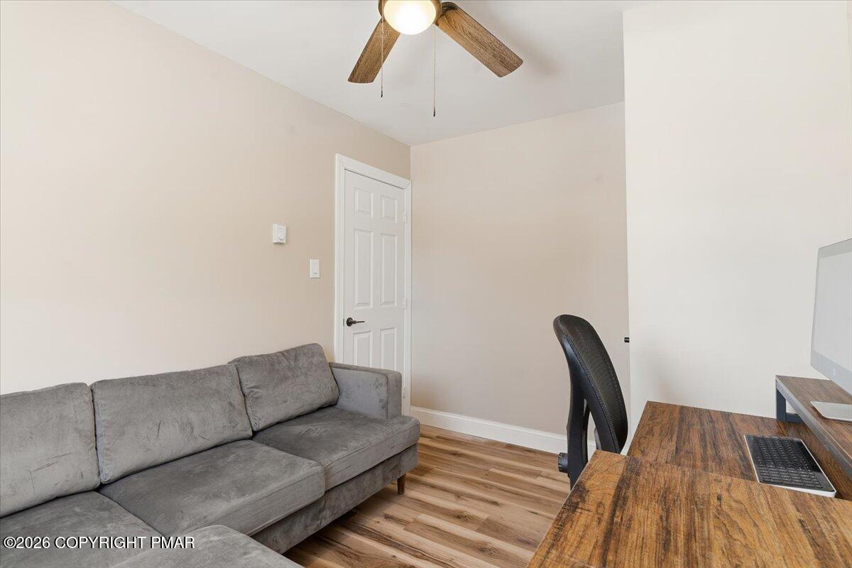 3279 Beech Ridge Drive Pocono Summit, PA 18346 - Photo 34 of 37 a living room with furniture and a wooden floor