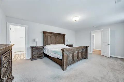 a bed room with a bed and a chair