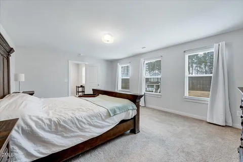 a spacious bedroom with a bed and window