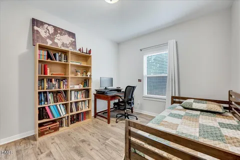 a view of a workspace with furniture and a bookshelf