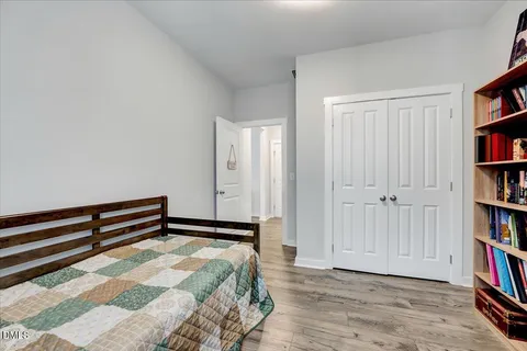 a bedroom with a bed and a book shelf