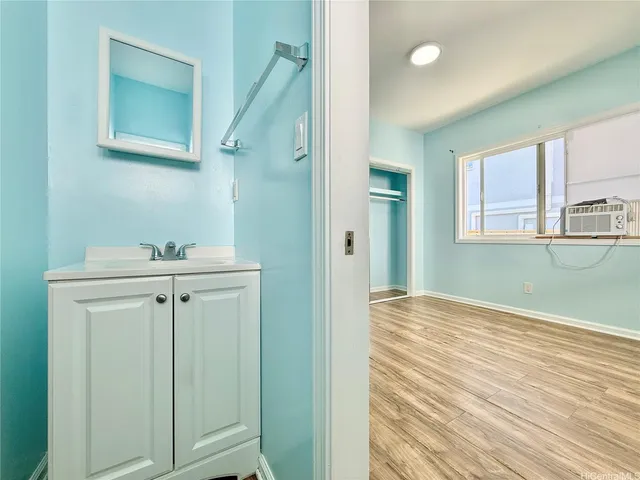 a view of a hallway with closet and wooden floor