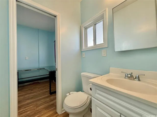 a bathroom with a toilet a sink and mirror