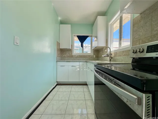 a kitchen with a sink stove and cabinets