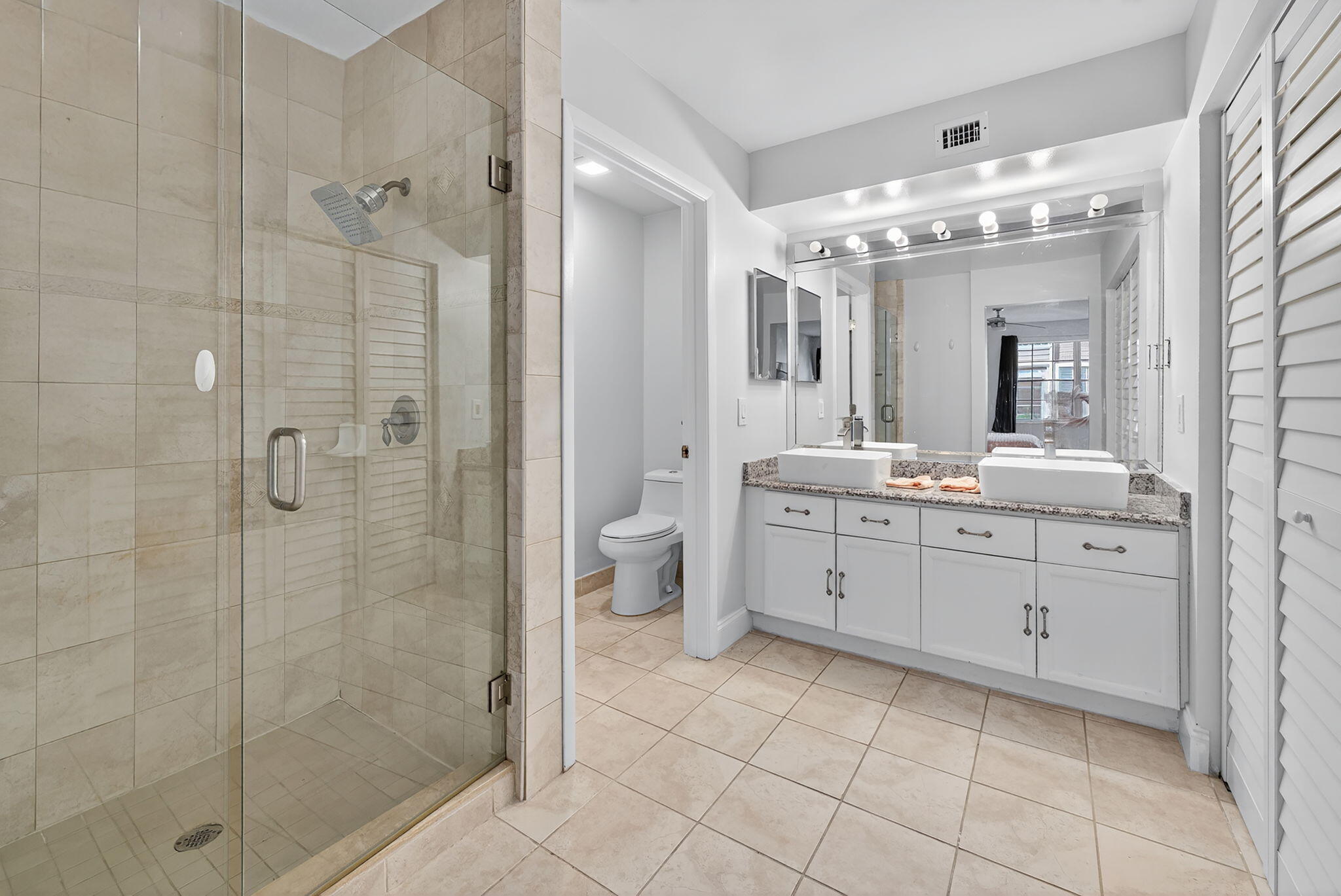 5332 Buckhead Circle, Unit 1010 Boca Raton, FL 33431 - Photo 23 of 30 a spacious bathroom with a double vanity sink mirror and shower