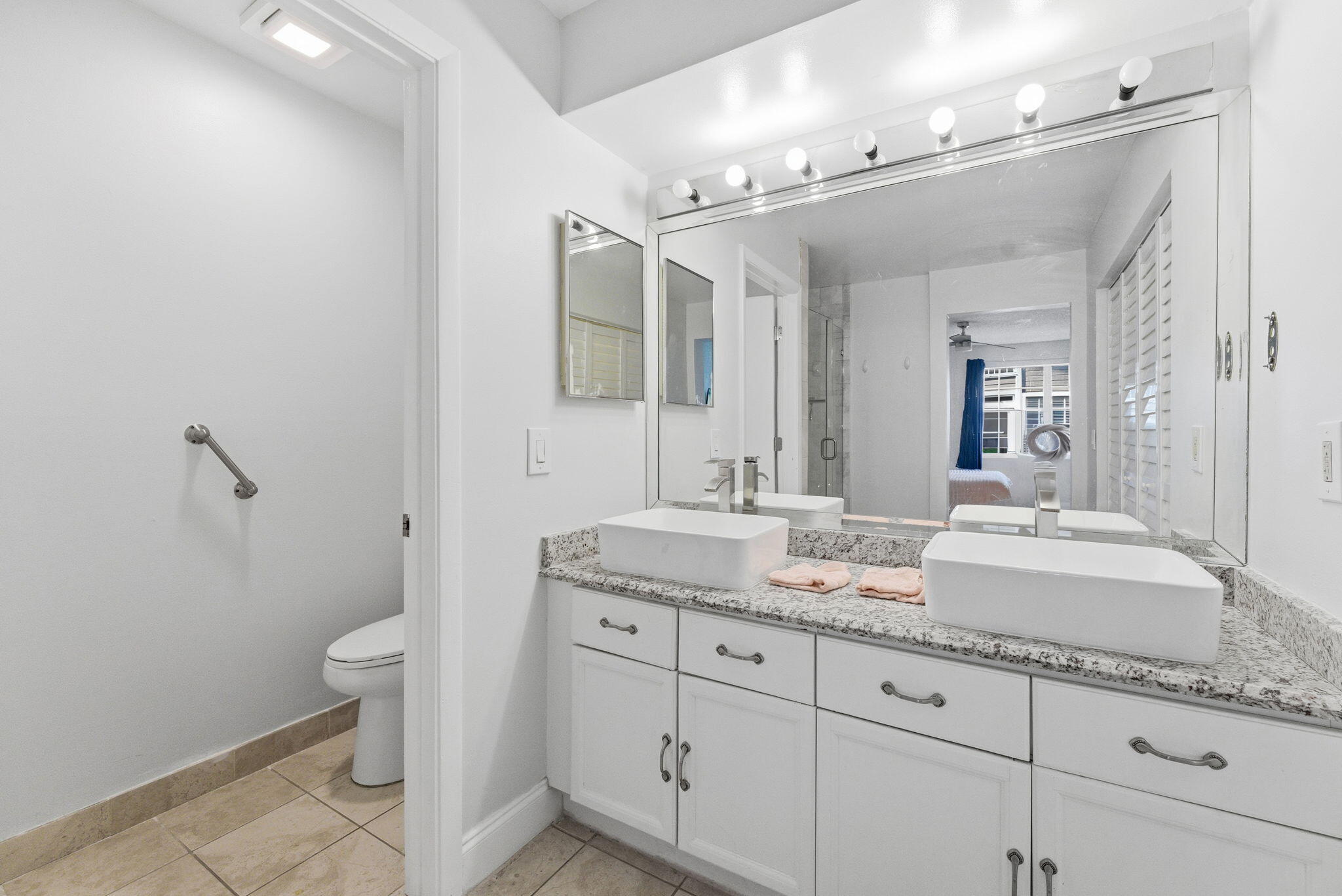 5332 Buckhead Circle, Unit 1010 Boca Raton, FL 33431 - Photo 25 of 30 a bathroom with a granite countertop sink mirror and toilet