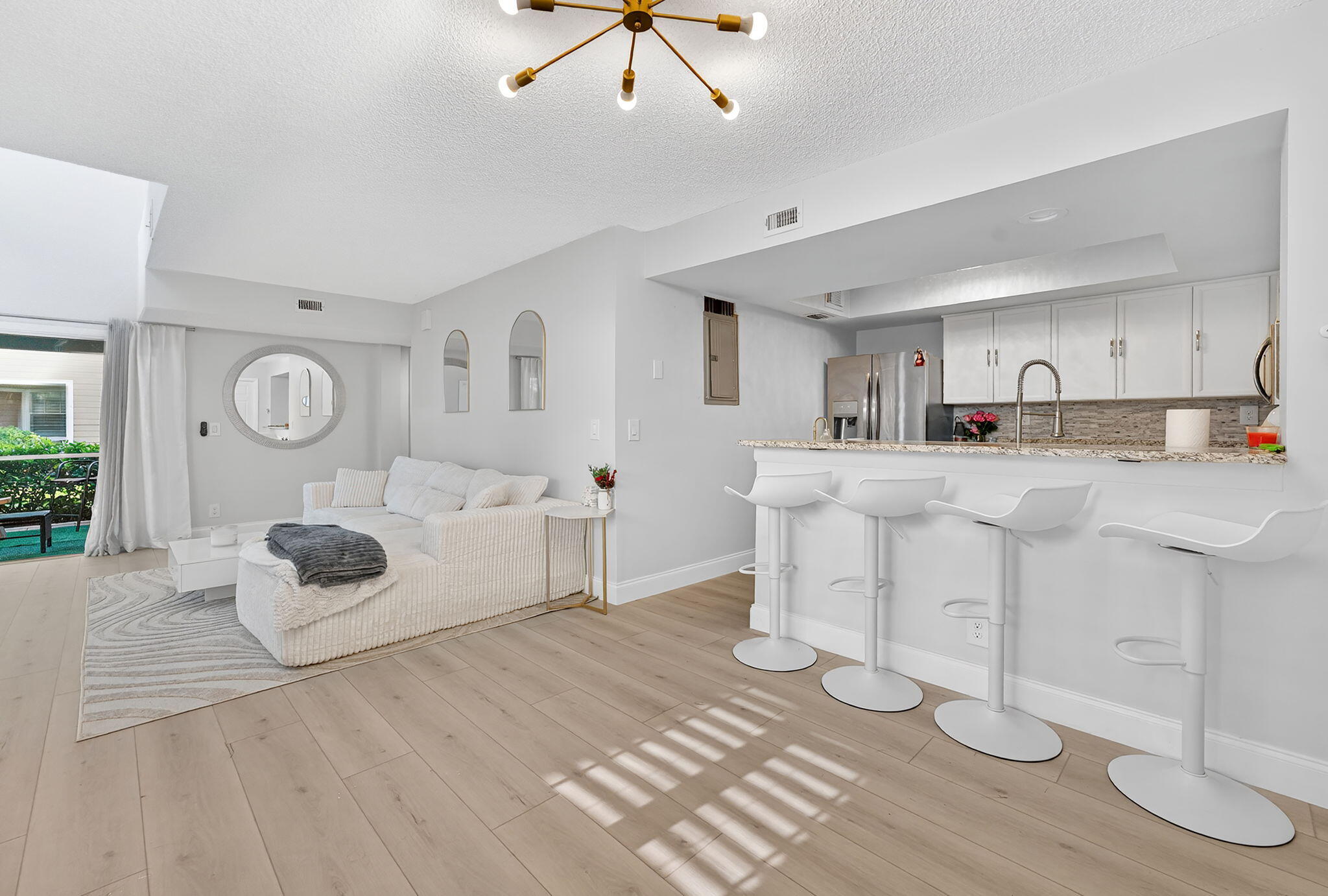 5332 Buckhead Circle, Unit 1010 Boca Raton, FL 33431 - Photo 10 of 30 a kitchen with white cabinets and sink