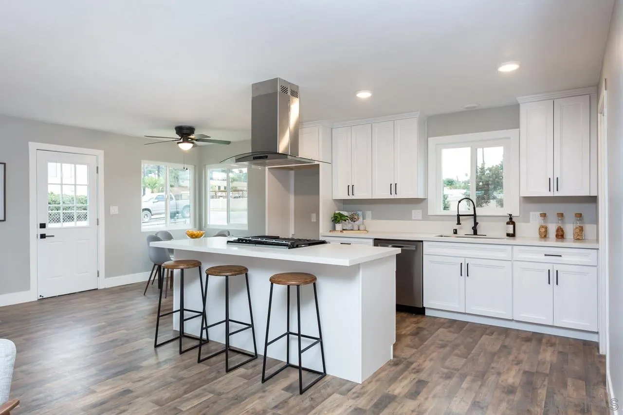 12055 Royal Road El Cajon, CA 92021 - Photo 12 of 34 a kitchen with stainless steel appliances a table and chairs in it