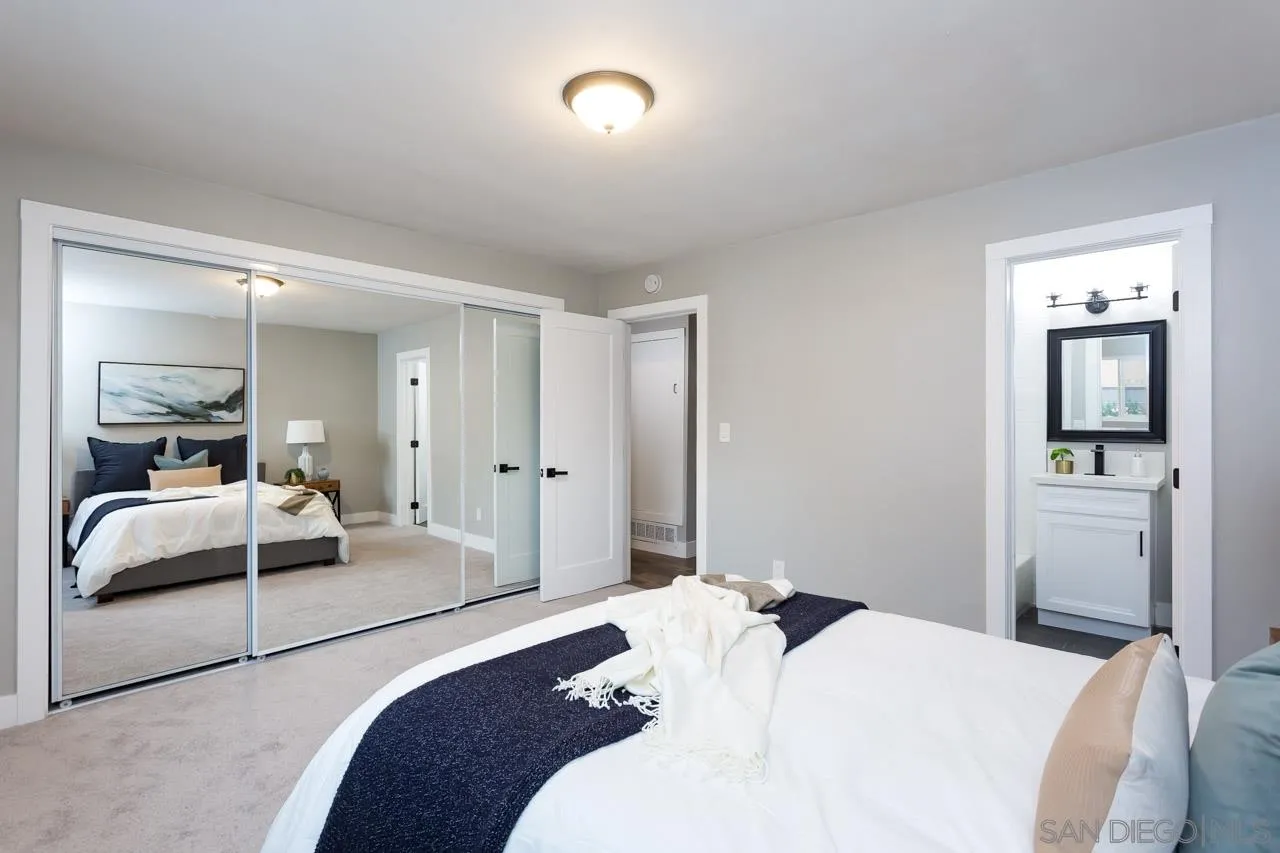12055 Royal Road El Cajon, CA 92021 - Photo 16 of 34 a bedroom with a bed and a large mirror