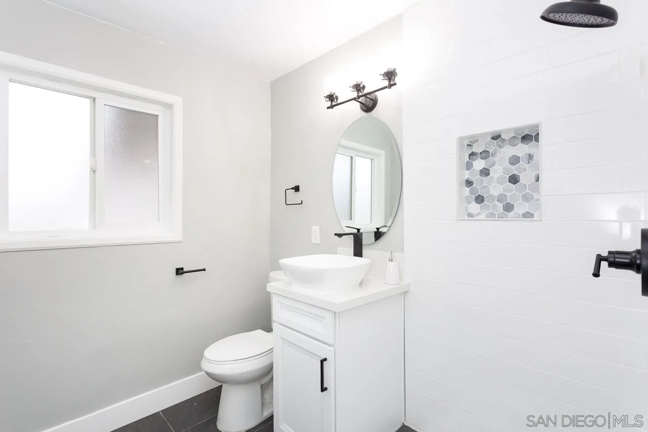 12055 Royal Road El Cajon, CA 92021 - Photo 18 of 34 a bathroom with a toilet sink and mirror
