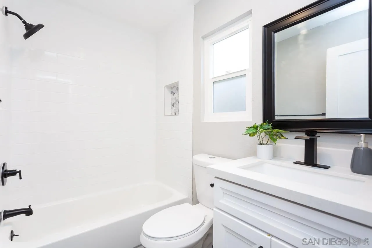 12055 Royal Road El Cajon, CA 92021 - Photo 19 of 34 a bathroom with a sink a toilet a mirror and shower