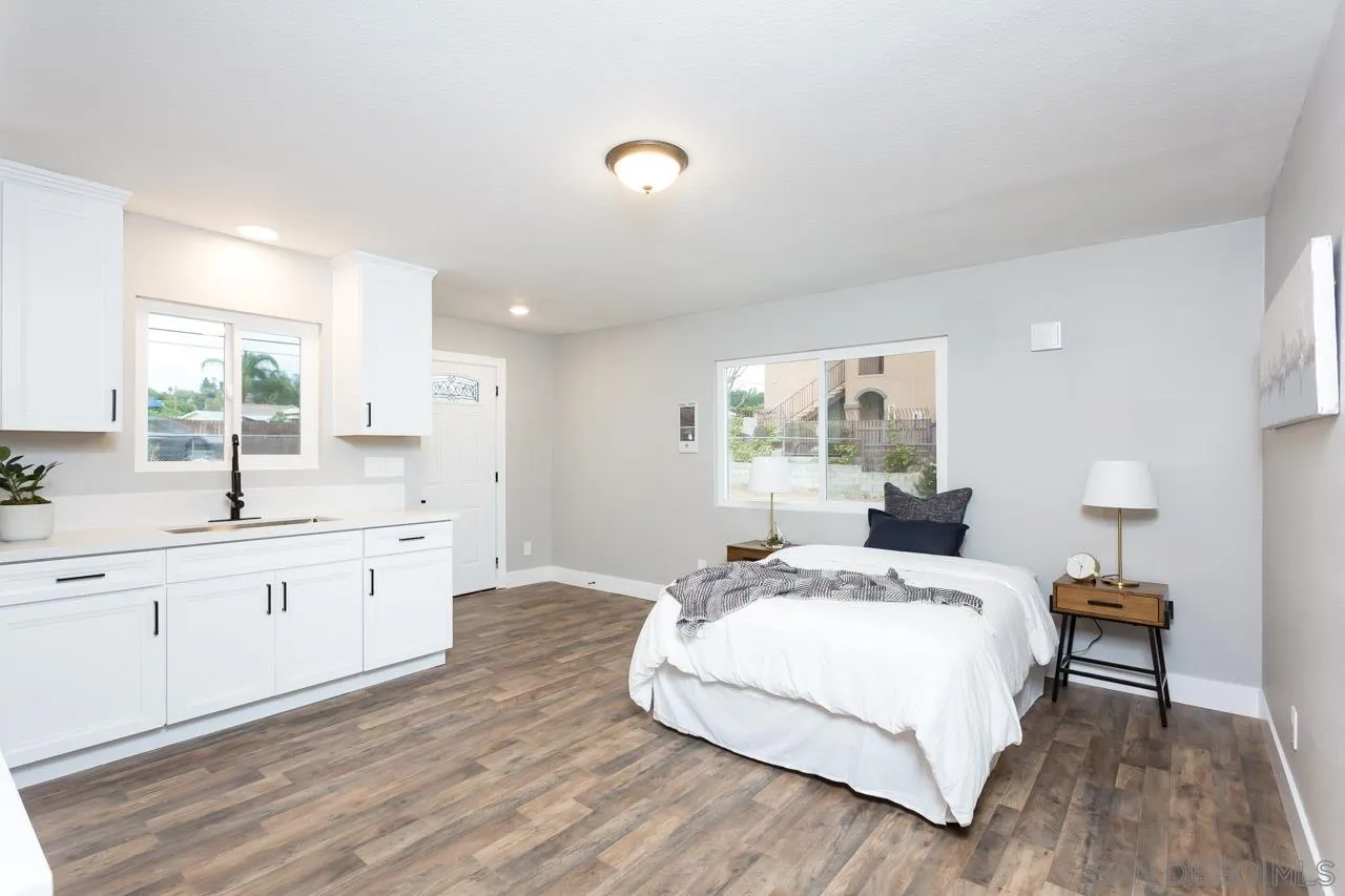 12055 Royal Road El Cajon, CA 92021 - Photo 24 of 34 a bedroom with a bed and a large window