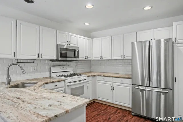 a view of a house with wooden fence
