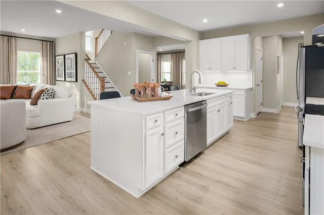 a large kitchen with stainless steel appliances a lot of counter space and wooden floors