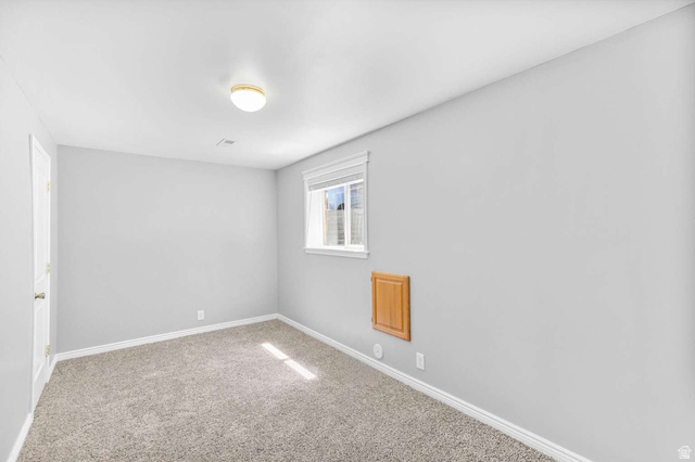 415 East 1150th Street North Logan, UT 84341 - Photo 22 of 38 Carpeted room with light grey walls, white baseboards, and a window with white trim and a roller shade