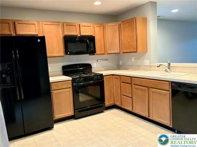 a kitchen with a sink stove and microwave