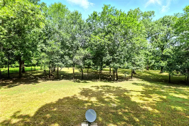 a view of a yard with swimming pool
