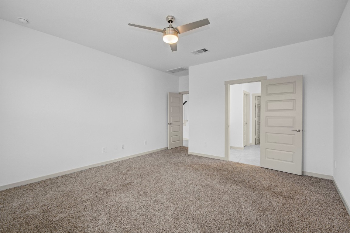 29847 Reagans Ranch Drive Katy, TX 77494 - Photo 17 of 36 an empty room with closet and a ceiling fan