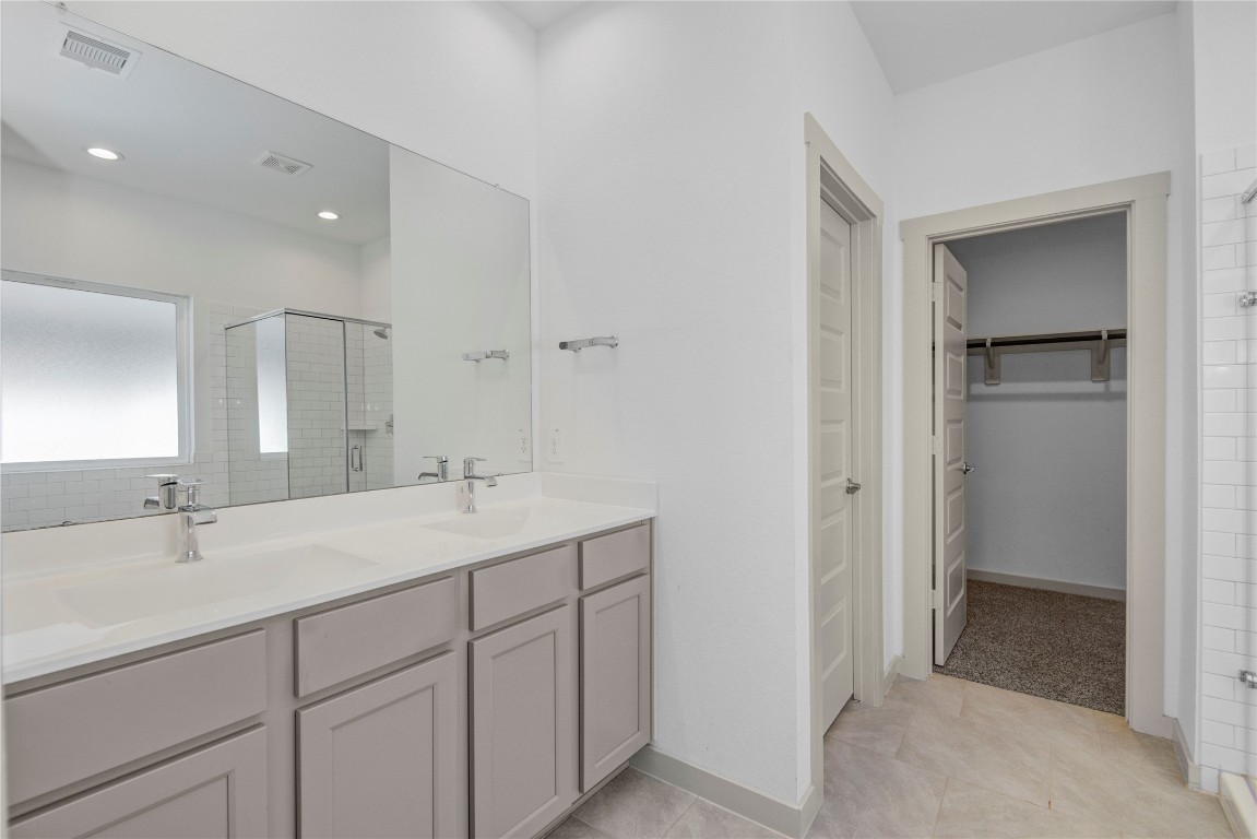 29847 Reagans Ranch Drive Katy, TX 77494 - Photo 18 of 36 a bathroom with a sink and a mirror