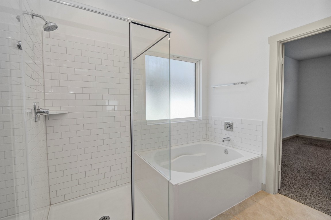 29847 Reagans Ranch Drive Katy, TX 77494 - Photo 20 of 36 a bathroom with a bathtub and shower