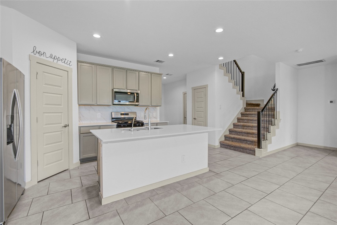 29847 Reagans Ranch Drive Katy, TX 77494 - Photo 9 of 36 a kitchen with cabinets and a stainless steel appliances