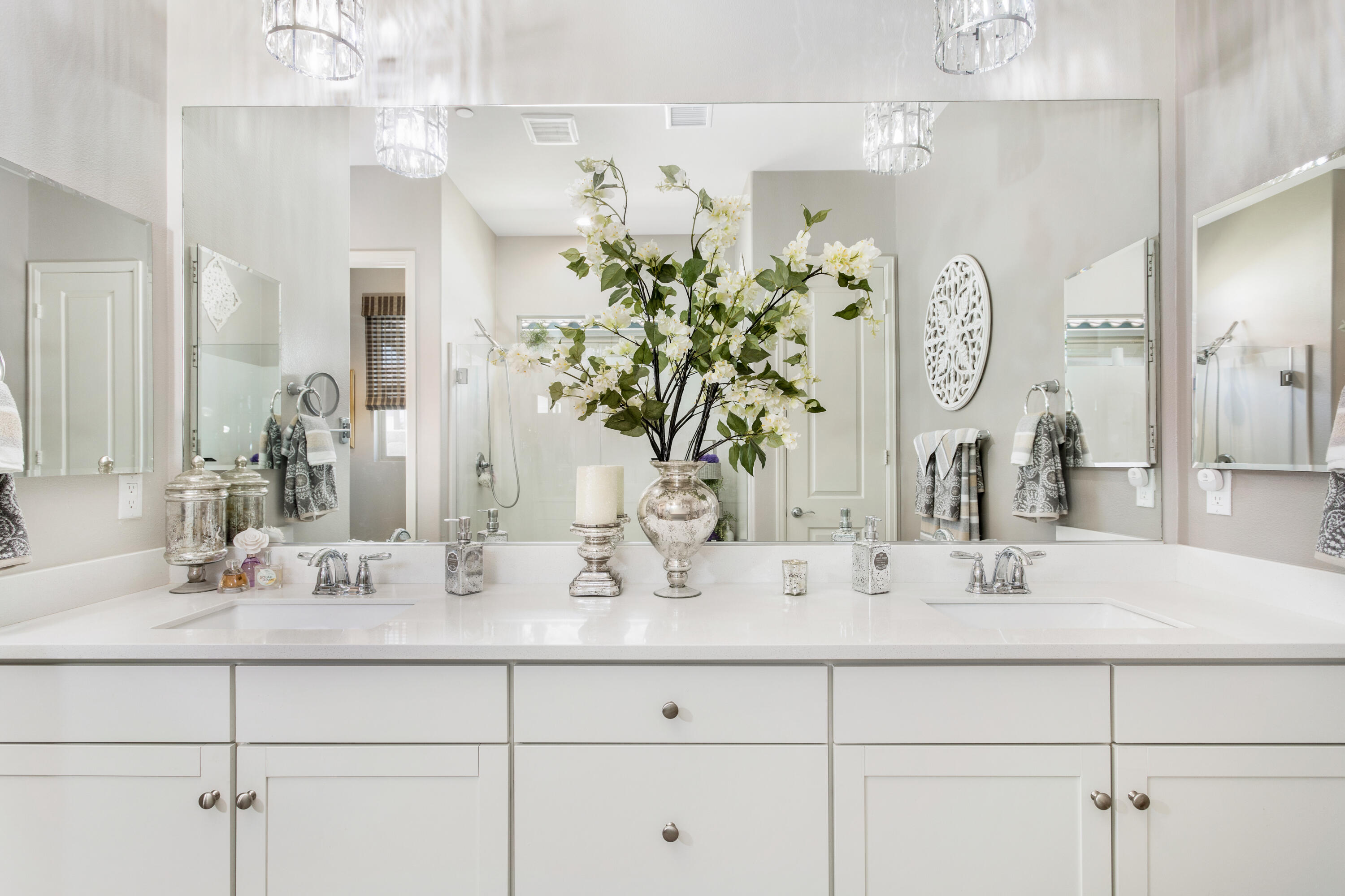 61 Syrah Rancho Mirage, CA 92270 - Photo 28 of 61 a bathroom with double vanity sinks a vanity a mirror and shower