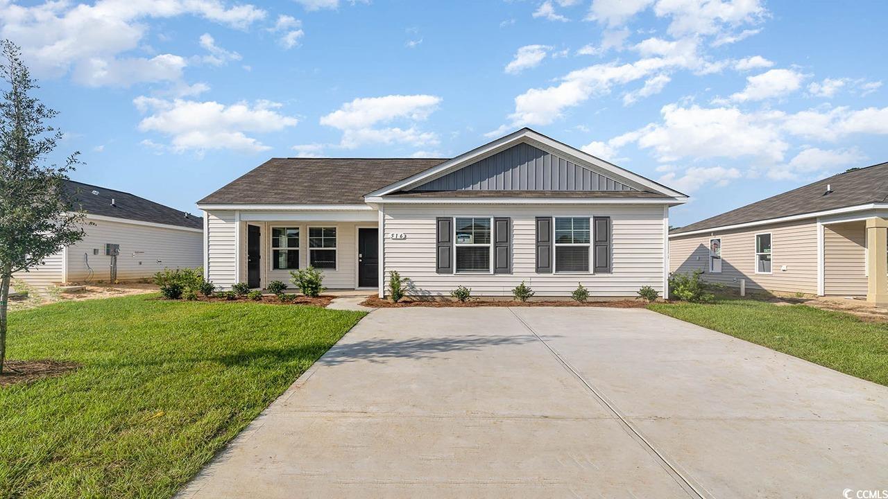 148 Dagger Court Myrtle Beach, SC 29588 - Photo 1 of 25 View of front facade with a front lawn, a porch, and board and batten siding