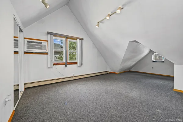 an empty room with staircase and white walls