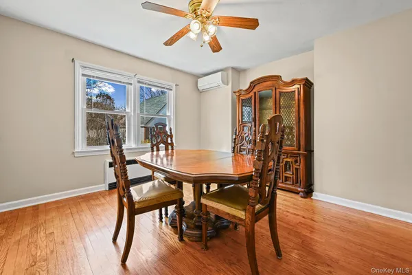 a view of a dining room with furniture window and wooden floor