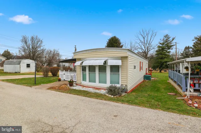 a view of a house with a yard and sitting area