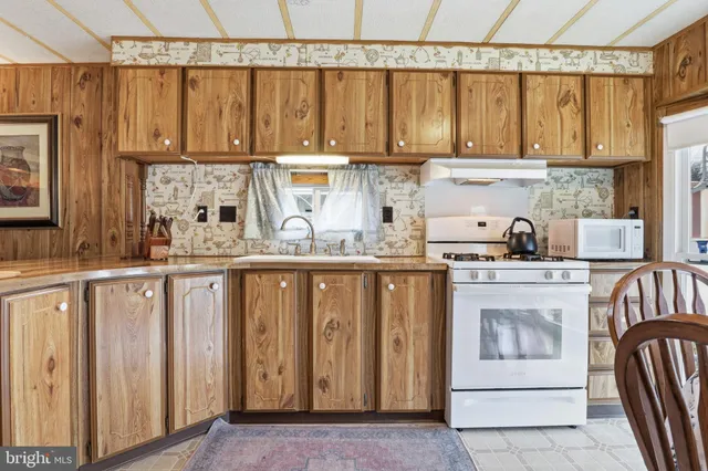 a kitchen with stainless steel appliances granite countertop a refrigerator sink and cabinets
