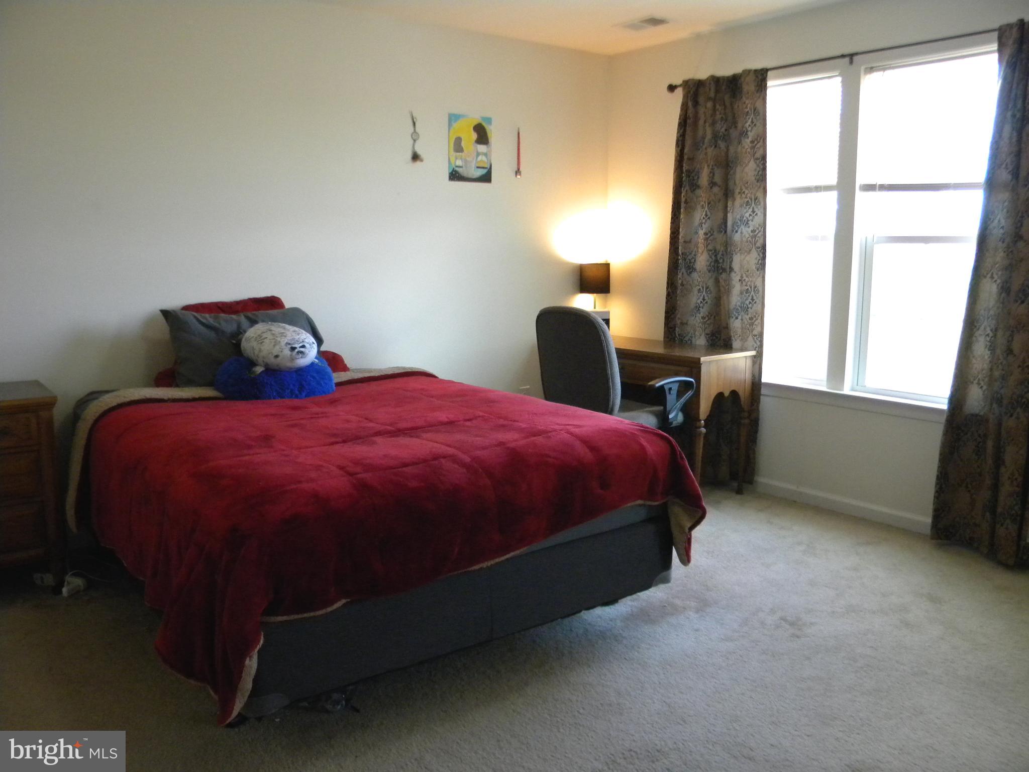 652 East Chestnut Street Souderton, PA 18964 - Photo 11 of 20 a bed sitting in a bedroom next to a window