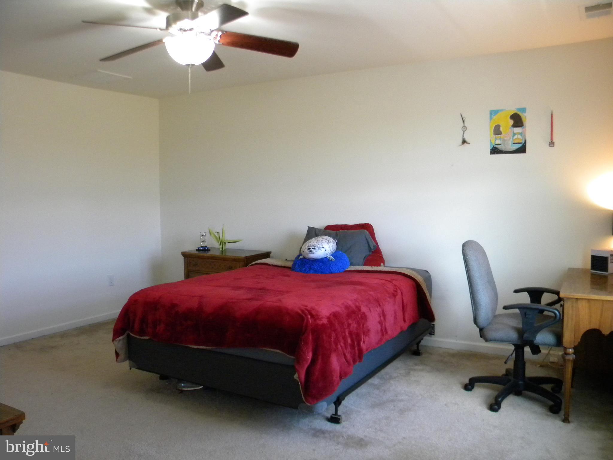 652 East Chestnut Street Souderton, PA 18964 - Photo 12 of 20 a bedroom with a bed a chair and a chandelier