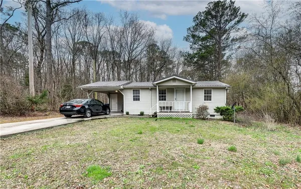 a view of a house with swimming pool and sitting area