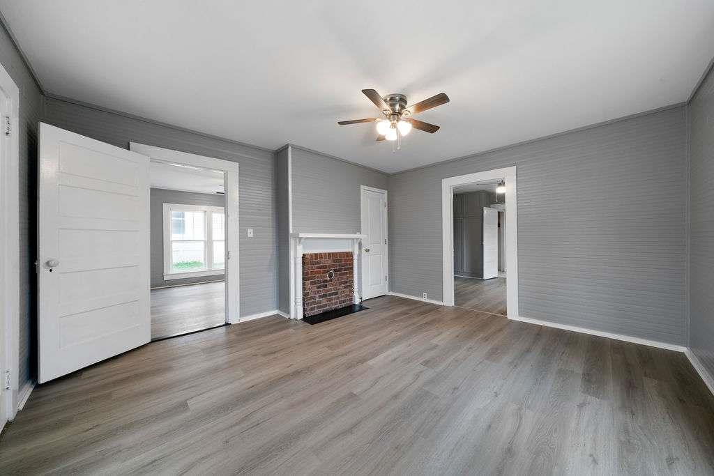425 North Marble Street Rockmart, GA 30153 - Photo 13 of 26 an empty room with wooden floor ceiling fan and windows