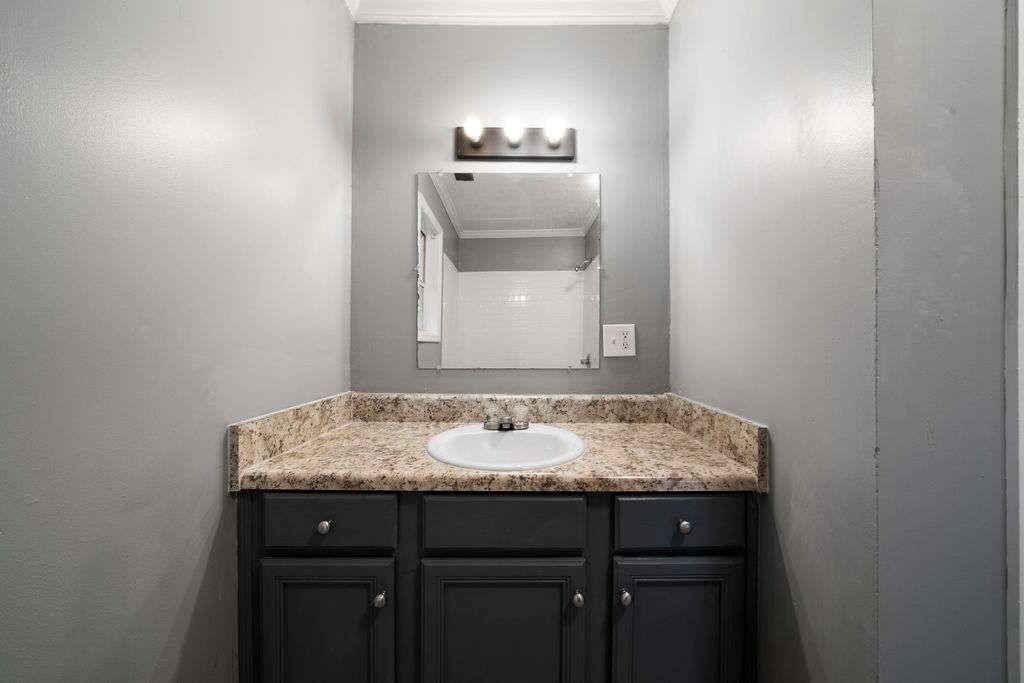 425 North Marble Street Rockmart, GA 30153 - Photo 20 of 26 a bathroom with a granite countertop sink and a mirror