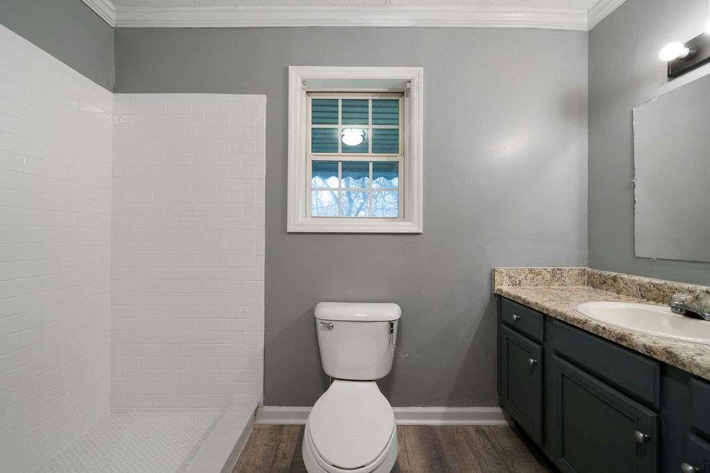 425 North Marble Street Rockmart, GA 30153 - Photo 5 of 26 a bathroom with a toilet sink and mirror