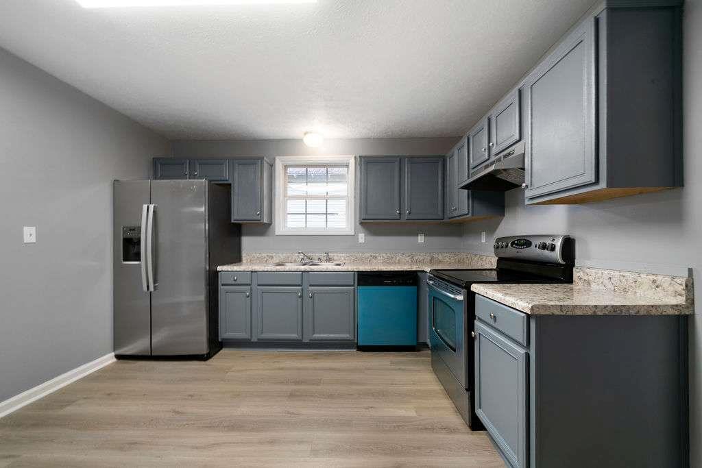 425 North Marble Street Rockmart, GA 30153 - Photo 8 of 26 a kitchen with granite countertop a sink stove and refrigerator