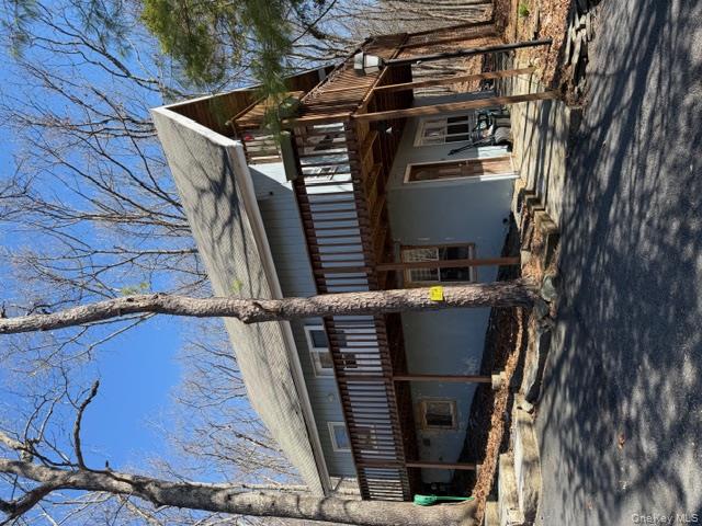 a view of a house with a patio and a yard