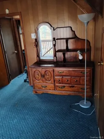 a view of an empty room with a cabinet