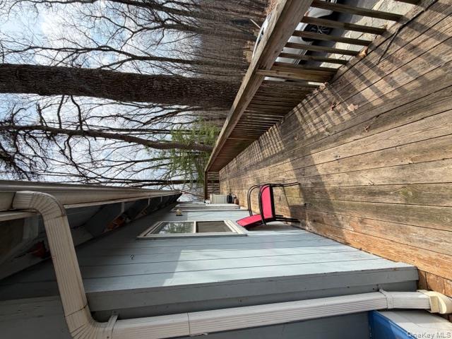 120 Swallow Court Bushkill, PA 18324 - Photo 9 of 39 a balcony with wooden floor and trees