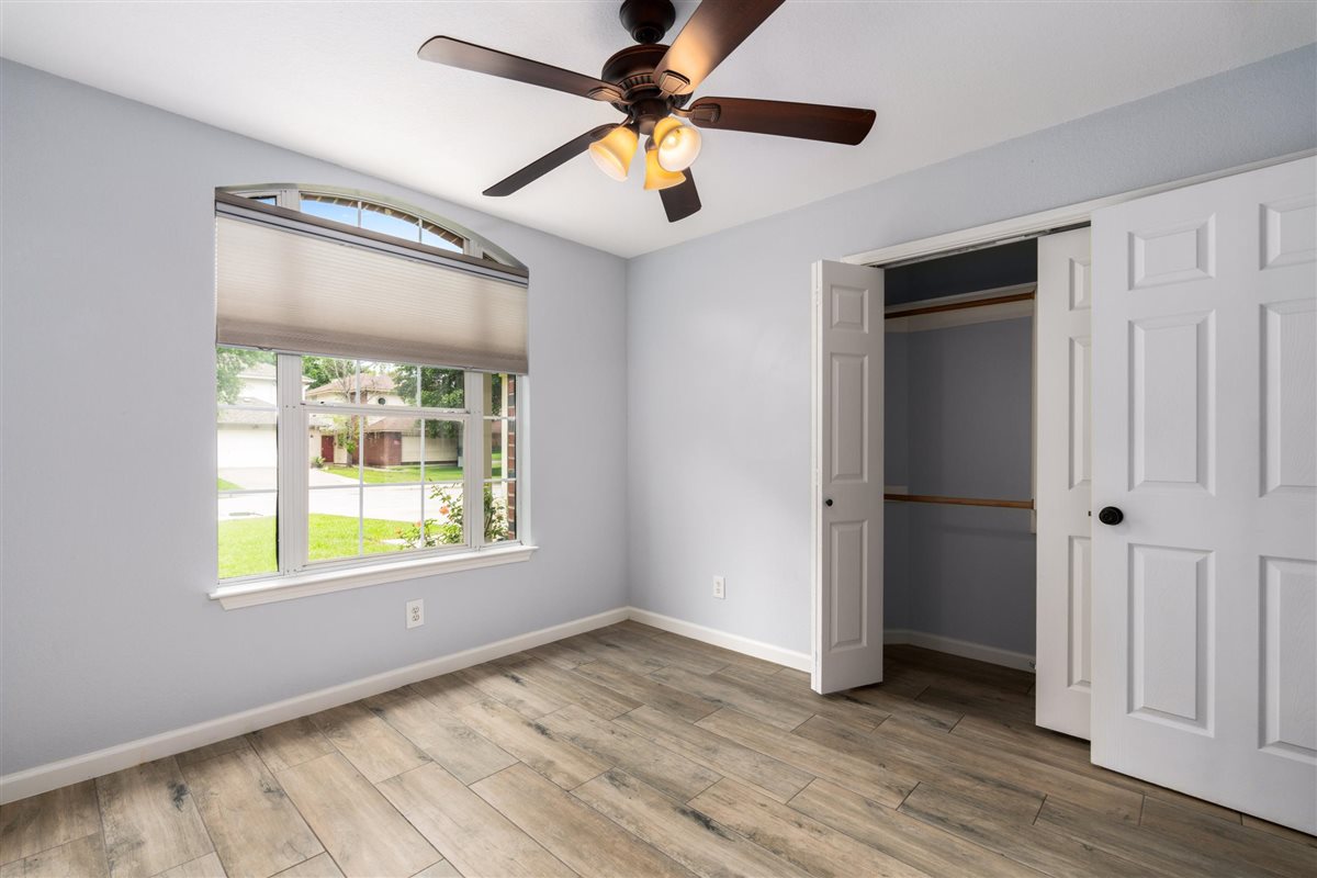 2147 Jasmine Path Round Rock, TX 78664 - Photo 22 of 36 The secondary bedroom features a charming arched window detail that fills the room with natural light.