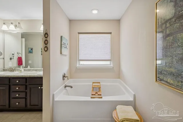 a bathroom with a granite countertop sink a toilet and bathtub