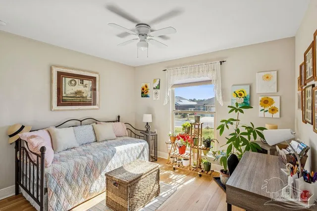 a bedroom with furniture and wooden floor
